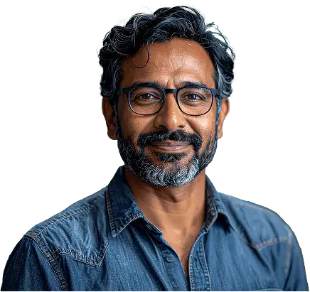 Middle-aged man with salt-and-pepper hair and beard wearing glasses and a denim shirt