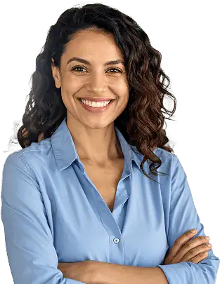 Smiling woman with long wavy dark hair wearing a light blue button-down shirt with arms crossed